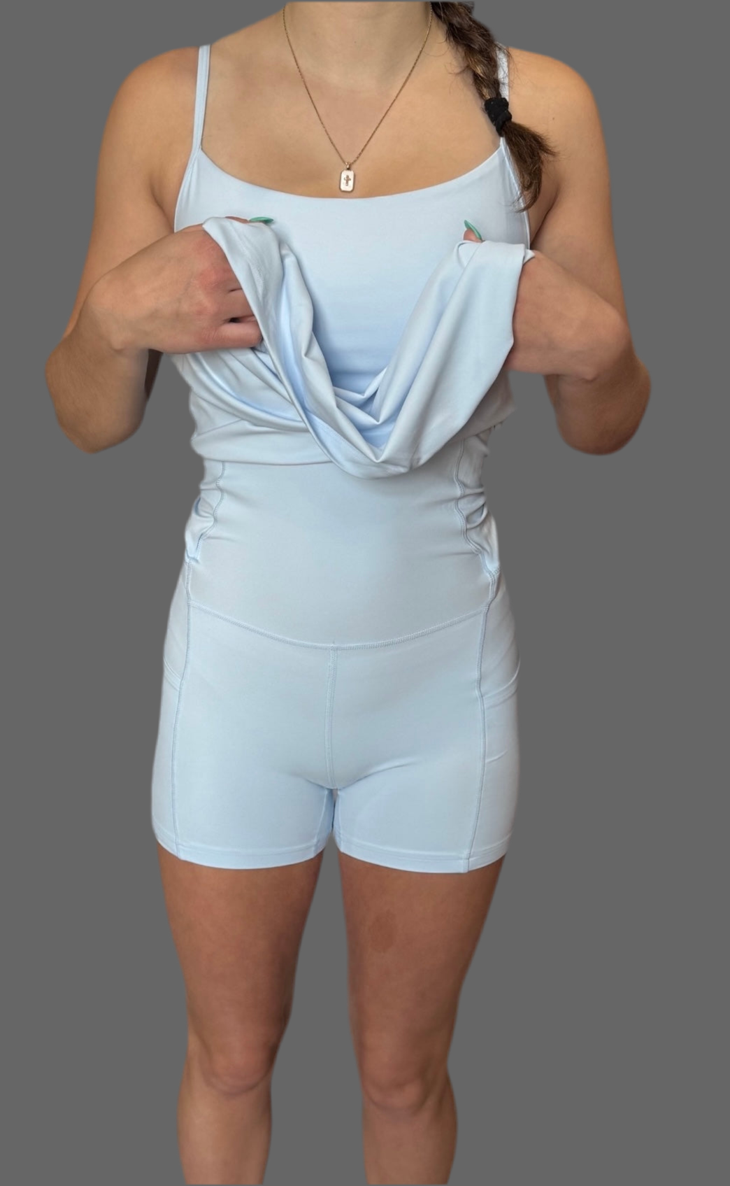 Front view of woman wearing baby blue Athena Active Dress lifted to reveal built-in shorts – Easy Peezy design for quick bathroom access by Sportik athletikS