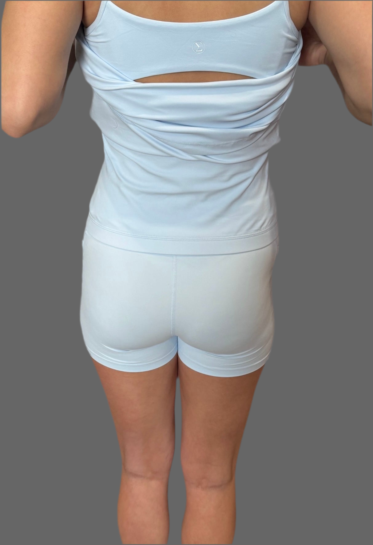 Back view of woman wearing baby blue Athena Active Dress featuring Easy Peezy bathroom-friendly design – athletic and functional women’s workout dress by Sportik athletikS