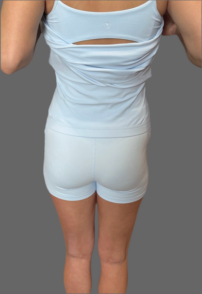 Back view of woman wearing baby blue Athena Active Dress featuring Easy Peezy bathroom-friendly design – athletic and functional women’s workout dress by Sportik athletikS