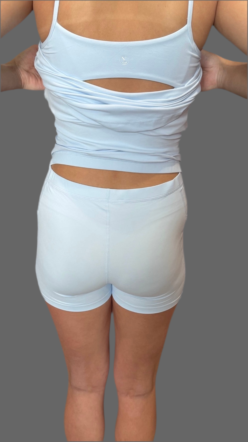 Back view of woman wearing baby blue Athena Active Dress featuring Easy Peezy bathroom-friendly design – athletic and functional women’s workout dress by Sportik athletikS