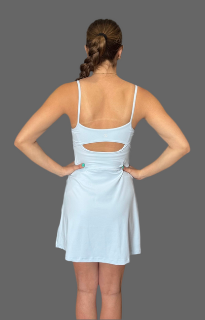 Back view of baby blue Athena Active Dress from Sportik athletikS, featuring open-back cutout, adjustable straps, and flowy skirt for stylish performance wear